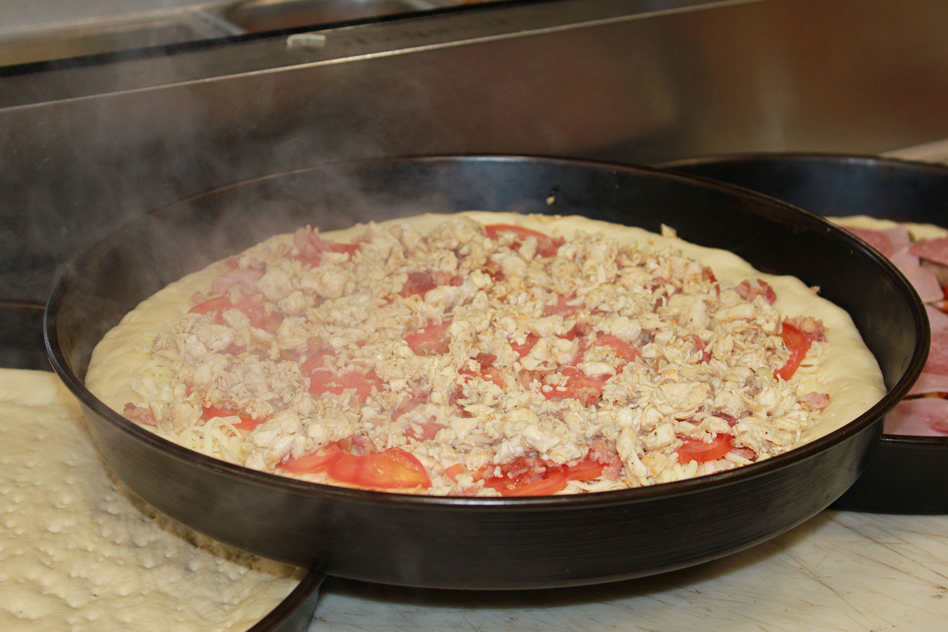 Pizzas being prepared for customers.